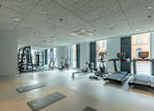 Thumbnail 27 of 27 - a gym with weights and other exercise equipment in a building with windows