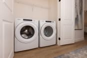 Thumbnail 26 of 38 - a washer and dryer sit next to each other in a laundry room