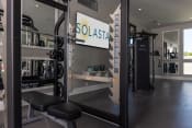 Thumbnail 24 of 40 - a gym with squat racks and a sign on the wall