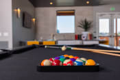 Thumbnail 13 of 40 - a games room with a pool table and billiard balls