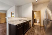 Thumbnail 45 of 126 - a kitchen with granite countertops and stainless steel appliances