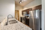 Thumbnail 49 of 126 - a kitchen with granite countertops and stainless steel appliances
