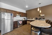Thumbnail 74 of 126 - a kitchen with a granite counter top and stainless steel appliances