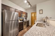 Thumbnail 79 of 126 - a kitchen with granite countertops and stainless steel appliances
