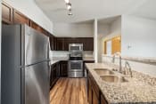 Thumbnail 95 of 126 - a kitchen with granite countertops and stainless steel appliances