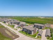 Thumbnail 123 of 126 - an aerial view of a large housing complex with a green field in the background