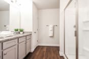 Thumbnail 60 of 61 - a bathroom with white walls and a wooden floor