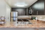 Thumbnail 5 of 33 - a kitchen with stainless steel appliances and a granite counter top