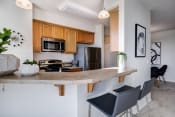 Thumbnail 1 of 37 - a kitchen with a large island with a granite countertop and wooden cabinets