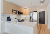 Thumbnail 1 of 54 - a kitchen with a white counter top and a stainless steel refrigerator