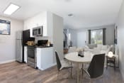 Thumbnail 9 of 15 - a kitchen and dining area in a 555 waverly unit