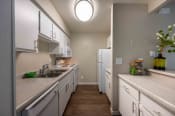 Thumbnail 39 of 60 - full kitchen with white cabinets and counter tops and stainless steel appliances