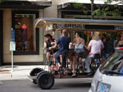 Thumbnail 39 of 44 - group of people pedal biking on booze tour through city at The Wyatt, Portland, Oregon