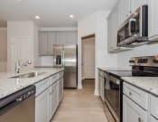Thumbnail 42 of 61 - a kitchen with white cabinets and stainless steel appliances