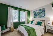 Thumbnail 7 of 41 - a bedroom with green walls and a bed with a large window