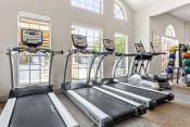 Thumbnail 33 of 40 - two rows of treadmills in a gym with windows at Aston at Cinco Ranch, Katy, TX, 77450
