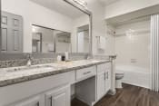 Thumbnail 10 of 40 - a bathroom with a sink and a toilet and a mirror at Aston at Cinco Ranch, Katy, 77450