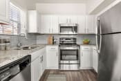 Thumbnail 1 of 40 - a kitchen with stainless steel appliances and white cabinets at Aston at Cinco Ranch, Katy, Texas