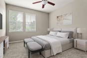 Thumbnail 4 of 28 - a bedroom with a bed and a ceiling fan at Villages of Cypress Creek, Texas