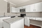 Thumbnail 1 of 28 - a kitchen with white cabinets and granite counter tops at Villages of Cypress Creek, Texas, 77070