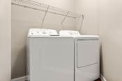 Thumbnail 7 of 28 - a washer and dryer in a room with a rack on the wall at Villages of Cypress Creek, Texas, 77070