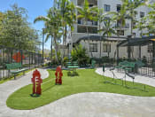 Thumbnail 17 of 22 - outdoor play ground | District West Gables Apartments in West Miami, Florida