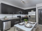 Thumbnail 1 of 22 - gourmet kitchen with granite countertops | District West Gables Apartments in West Miami, Florida
