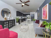 Thumbnail 2 of 22 - a view of a living room with chairs and a table at District West Gables, West Miami, FL