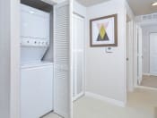 Thumbnail 6 of 22 - a white room with a bathroom and a closet at District West Gables, West Miami, 33155