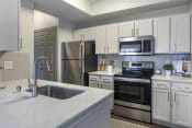 Thumbnail 12 of 16 - a kitchen with white cabinets and stainless steel appliances at Lakeshore at Preston, Plano, TX