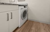 Thumbnail 12 of 24 - a front loading washer and dryer in a laundry room with a counter top at South Lamar Village, Texas