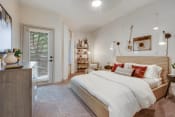 Thumbnail 8 of 19 - a bedroom with a bed and a door to a closet at The Olivine, Austin, Texas