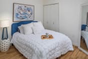 Thumbnail 8 of 41 - a bedroom with white walls and a blue headboard at The Parker Apartments, Oregon, 97209