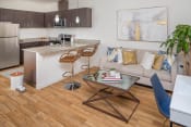 Thumbnail 4 of 41 - a living room and kitchen with wood flooring at The Parker Apartments, Oregon, 97209
