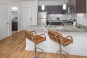 Thumbnail 1 of 41 - a kitchen with an island and two bar stools in front of it at The Parker Apartments, Portland, 97209