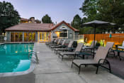 Thumbnail 14 of 17 - a pool with a row of lounge chairs next to a house at Verdant, Colorado