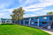 Thumbnail 7 of 33 - the building where the motel is located is painted blue and has a green lawn