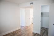 Thumbnail 16 of 17 - a bedroom with hardwood floors and white walls