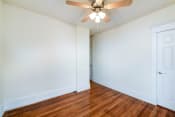 Thumbnail 15 of 20 - vacant bedroom with hardwood flooring and ceiling fan at the cortland apartments in washington dc