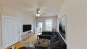 Thumbnail 6 of 34 - living area with sofa, coffee table, credenza, tv, ceiling fan and view of balcony at dupont apartments in washington dc
