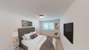 Thumbnail 7 of 22 - bedroom with bed, nightstands, large windows and tv at cambridge square apartments in bethesda md