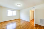 Thumbnail 15 of 22 - vacant living area with large windows, hard wood flooring and view of hallway in cambridge square apartments in bethesda md