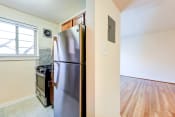 Thumbnail 4 of 22 - kitchen with stainless steel appliances and wood cabinetry at cambridge square apartments in bethesda md