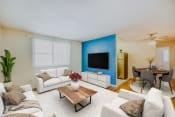 Thumbnail 4 of 16 - a living room with a blue accent wall and a white couch