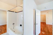 Thumbnail 14 of 30 - bathroom with tub and views of bedroom and living areas at hampton courts apartments in washington dc