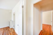 Thumbnail 13 of 30 - vacant apartment with hardwood floors and view of living and bedroom areas at hampton courts apartments in washington dc