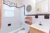 Thumbnail 6 of 16 - bathroom with toilet, tub, vanity and mirror at jetu apartments in washington dc