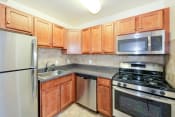 Thumbnail 1 of 10 - kitchen with stainless steel appliances at naylor overlook apartments in skyland washington dc