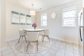 Thumbnail 6 of 16 - dining area with table, chairs, windows and tile flooring at sheridan station south townhomes in washington dc