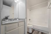 Thumbnail 48 of 48 - a bathroom with a sink and a toilet and a shower at Monterra Ridge Apartments, Canyon Country, CA